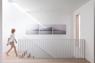 A skylight creates interesting light play at the top of the staircase landing.