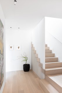A staircase with Nordic Oak treads and a slatted steel guardrail.