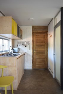 The kitchen area and living/dining spaces are located on the first level, along with a bathroom.