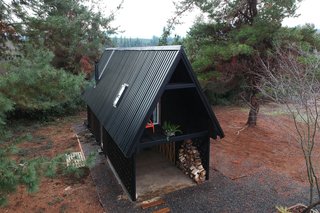 Lagos has raised the cabin above the ground on supporting steel to avoid damaging any of the existing trees on site. 