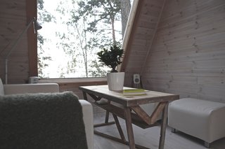 On the lower level is the living lounge where Falck can relax and look out at nature through a massive window that is spread across the two floors.