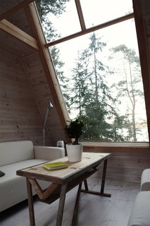 The window looks out to views across the lake, while also bringing in sunlight to help brighten the interiors. 