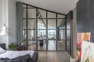 The entrance to the master bedroom is through a sloped wall of framed windows. 