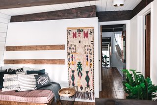 A lounge area sits at the top of the staircase landing.