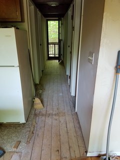 Before, the old house had water-stained walls, cheap linoleum flooring, beams painted a dull chocolate brown, and a garish pink kitchen counter.