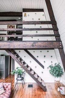 From the living lounge, wooden stairs lead up to the bedrooms.