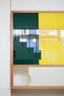 Plexiglass panels have been used for for the kitchen cabinets and staircase shelving.