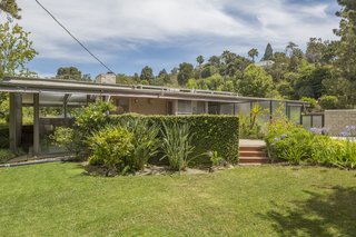 Sited on a flat lot, the property includes two generous, enclosed yards that can accommodate expansions or the addition of a pool.