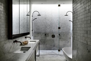 A bathroom with natural stone floor and walls.