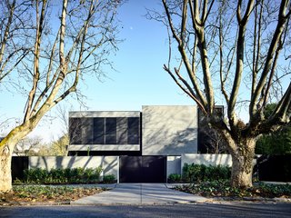 Unfolding dramatically from the street, the 5,920-square-foot mansion, which includes a basement garage, is conceived as a three-story box embedded in sunken gardens, with a top section that cantilevers over glass rooms. 