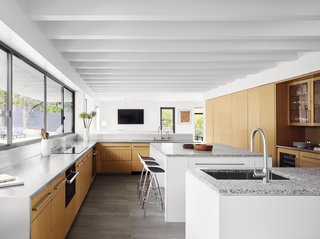 Porcelain-colored tile has been used in the kitchen and bathrooms.