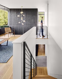 The large windows open up the interiors by creating double-height spaces that draw natural light into the heart of the house. 