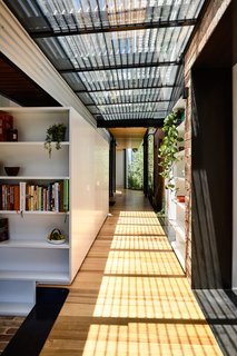 With the entry relocated, the original terrace entrance porch was transformed into a garden, and the entry corridor was repurposed as a bathroom.