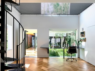 The stable was repurposed as a garage and a retreat space for the parents.
