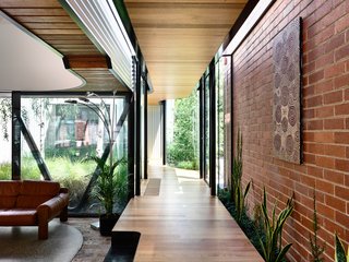 This new corridor connects the original house with the remodeled stable, and a new pavilion where the kitchen, living, and dining areas are located.