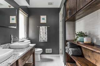 In the new master bathroom, the roll-under vanity allows Derek to get close to the sink when he gets ready in the morning. 