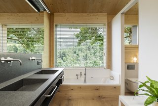 The showers and bathrooms, positioned along the exterior walls, benefit from natural light and ventilation.
