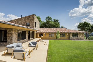 Pablo Serrano Elorduy, founder of Barcelona studio Dom Arquitectura, used three different materials—the mandatory stone and the clay tiles, and a timber framework—for the foundation of the house, then incorporated iron for additional joint support. 