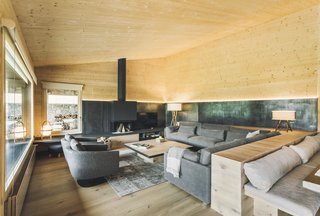 The L-shaped house has two perpendicular wings: one that contains the common areas, and another that contains the bedrooms.