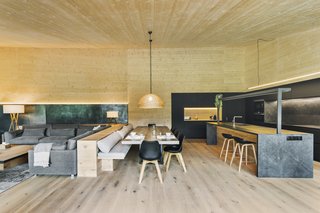 The living, dining, and kitchen spaces flow into one another.