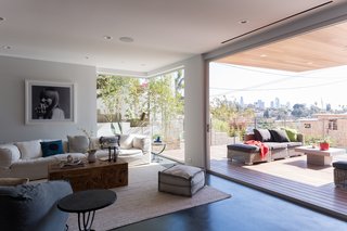 The next level holds a living/dining area with a powder room and entertainment area. 