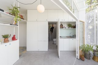 One of the kitchen's panel doors opens to reveal a hidden bathroom.