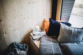 The bench along the window can be transformed into a guest bed.