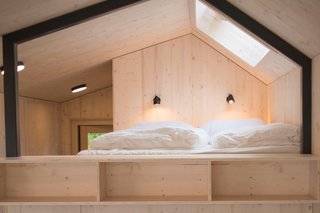Under the bed platform is a large wardrobe, storage spaces, and a USB docking station.