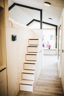 Steps with built-in drawers lead up to the sleeping loft.
