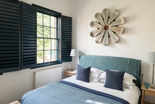 The original sash windows were upgraded, painted a rich blue color, and fitted with a double set of internal Venetian shutters. 