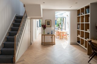 From the landing, a half flight of stairs leads to the two bedrooms on the first floor.