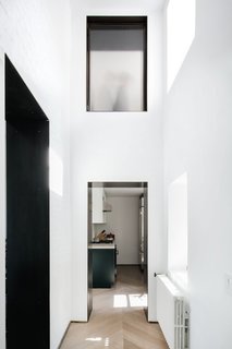 While the apartment's floor area is modest, its high walls give the space a lofty, voluminous feel.