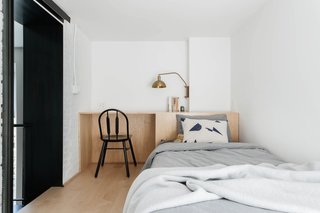 A work desk connects to the headboard.