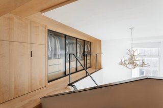 The two lofts are wrapped in maple carpentry, and the warmth of the material works with the compactness of the space to create the most intimate rooms in the apartment. 
