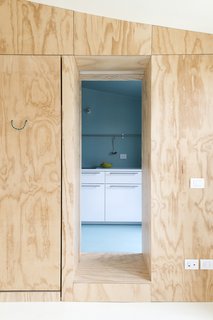 A look at the pinewood-paneled corridor that leads into the kitchen.