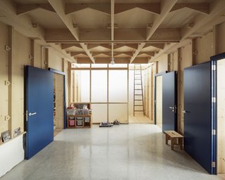 Raw wood, stone, and terra cotta complement the unvarnished plywood.