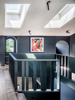 A hand-assembled metal staircase leads up to the attic floor.