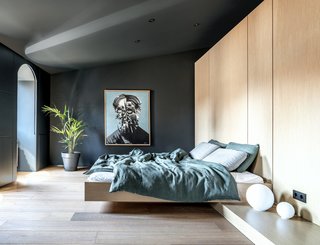 Artwork by Ukrainian artist Bohdan Burenko, and Artemide bedside lamps in the bedroom.