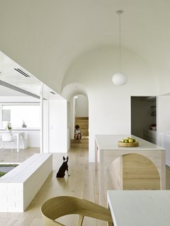 In the kitchen, which functions as the heart of the house, the architects have created a geometrically pure, double-height barrel vault. 