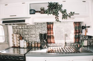For the kitchen they incorporated a cool, pressed tin backsplash from Lowes, which brings the metallic of Augustine’s exteriors indoors. 