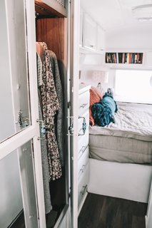 "Design strategies we used to maximize space include utilizing the space underneath the bed and the front shelving, and making those areas accessible with additional doors," says Taylor. "Nate built a hidden shoe cubby into the bed frame, and we left the large hallway closet as is to increase our storage options."