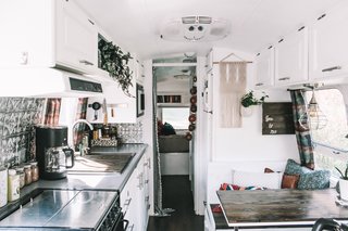 For the dining area, the Lavenders replaced the existing booth, table, and seats, and added double windows and layers of textured throw pillows to make this a warm and comfortable space.