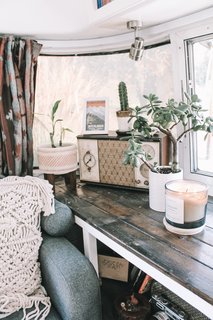 A macrame throw pillow from Etsy, geometric table lamp from Target, and vintage radio add texture and character.