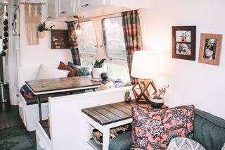 In the dining area hangs an industrial case pendant light shade from Lowes, and macramé wall art from a friend.