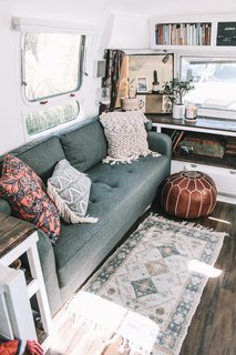 A midcentury modern sofa from Wayfair and an infrared quartz electric fireplace purchased through Amazon completes the cozy living lounge.