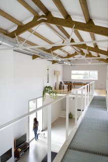 A catwalk corridor leads to a sunlit leisure lounge with a pool table.