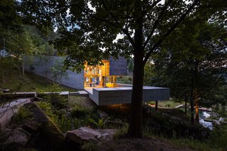A section of the concrete volume cantilevers above the brook that connects the two ponds.