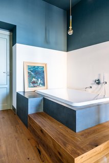 This bathroom features tadelakt cement and Wet System Wall & Deco wallpaper. 