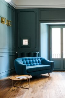 LYGA reconstructed this living space with vaulting that is wider than the existing vaulting and plaster wall frames in a gray-green color.