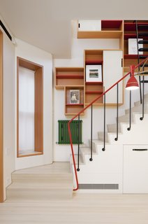 Benjamin Moore paint in bold primary colors grace the shelves, stair rails, and radiators.